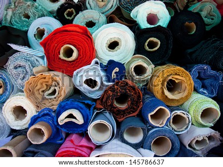 multicolored rolls of fabric at a flea market