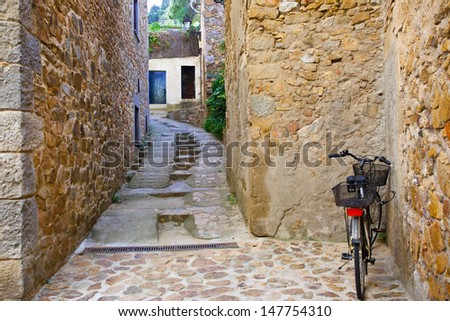 cobbled streets and stone walls of the ancient town and a bike
