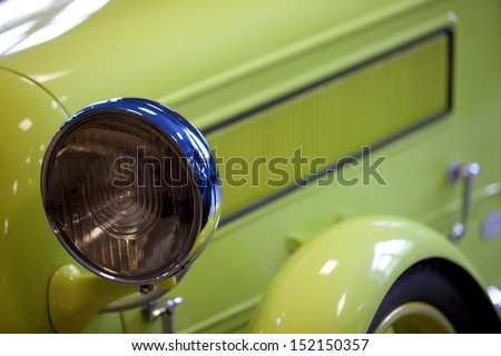 fragment of a green old car of 30-40-th with headlamp