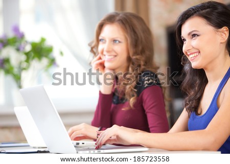 two students in class, two young woman with computers