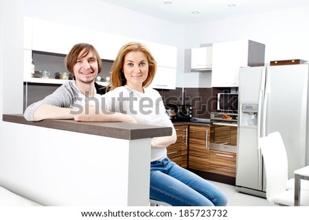 Smiiling Couple Relaxing In New Home