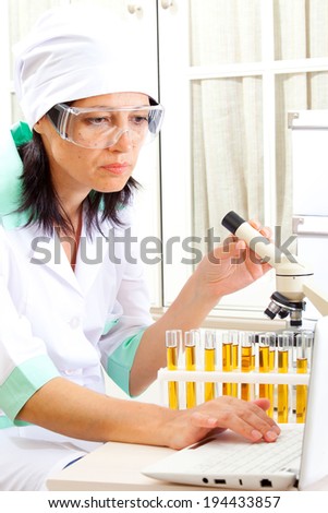 female scientist microscoping in the life science research laboratory (genetics, biochemistry, forensics, microbiology)