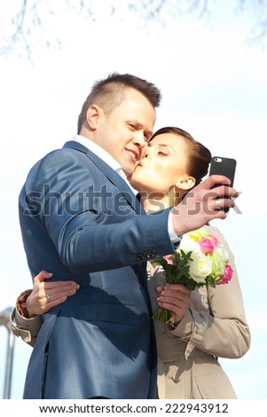 beautiful bride and groom make selfie wedding kiss