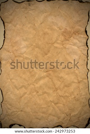 sheet of aged paper burnt at the edges