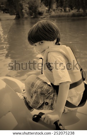 boy in a life jacket on a background of the water, instagram image style