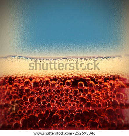 cola with bubbles and foam close up. carbonated beverage. close-up. instagram image style