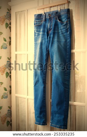 jeans on hangers on the door wardrobes. instagram image retro style