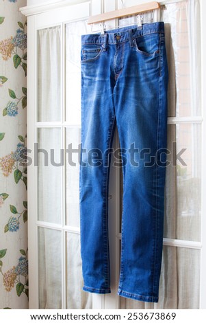 jeans on hangers on the door wardrobes