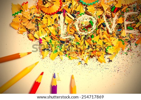 The word Love on the background of colored pencil shavings. instagram image retro style