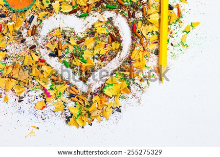 heart, yellow pencil and colored wooden chips