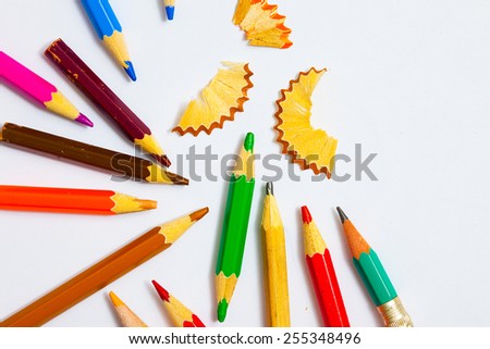 set of a vintage colored pencils with shavings on the white background