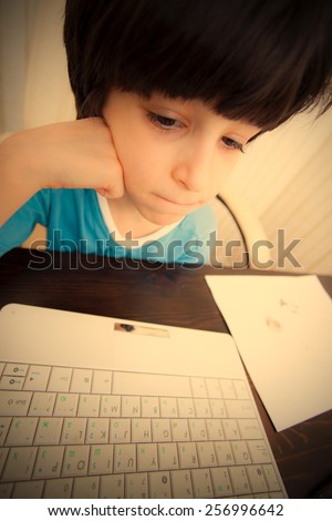 boy with computer in the interior, distance learning. instagram image retro style