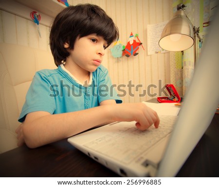 distance learning, a boy with computer in the interior. instagram image retro style