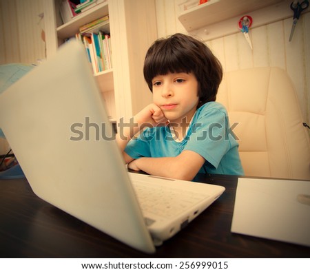boy with computer in the interior, distance learning. instagram image retro style