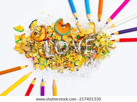 word Love on the background of colored pencil shavings