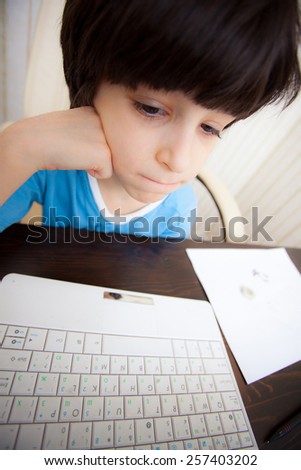 boy with computer in the interior, distance learning