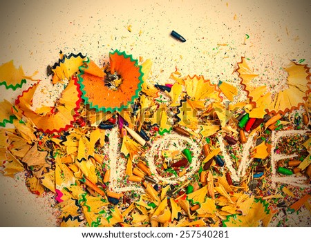 word Love over a shavings of pencils for drawing with copy space. instagram image retro style