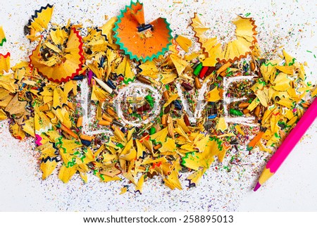 word Love over a shavings of pencils for drawing
