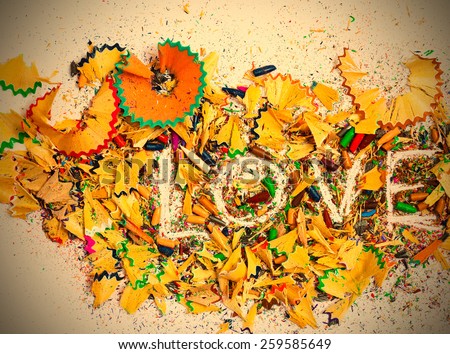 word love on the background of colored pencil shavings. instagram image retro style