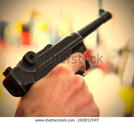 Parabellum automatic pistol in a human hand, shallow depth of field. close-up. instagram image retro style
