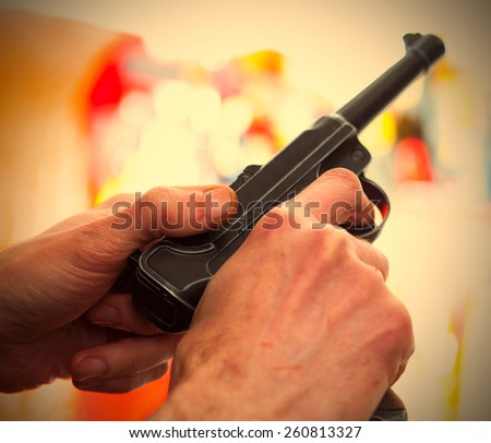 Luger Parabellum automatic pistol in a hands, shallow depth of field. close-up. instagram image retro style