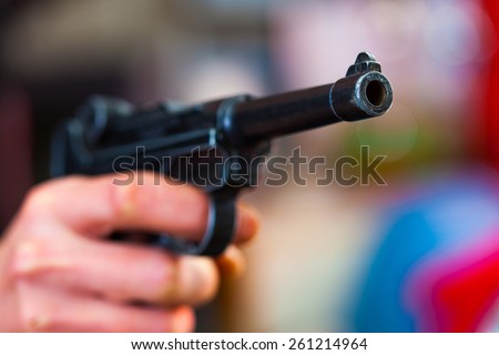 Luger Parabellum automatic pistol in a human hand, shallow depth of field. close-up