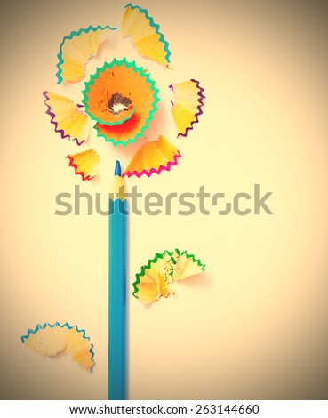 art flower from blue pencil and colored shavings on white background. instagram image retro style