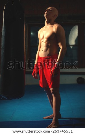 portrait of athlete in red shorts in gym. instagram image retro style