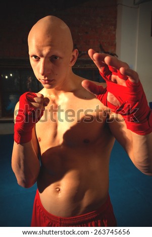 Portrait of a fighter with fists in red bandages near the face. instagram image retro style
