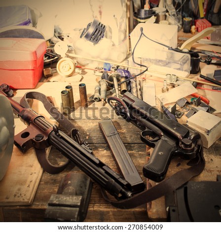 MP38 sub machine gun on the table master restorer in the interior locksmith gunsmith. instagram image retro style