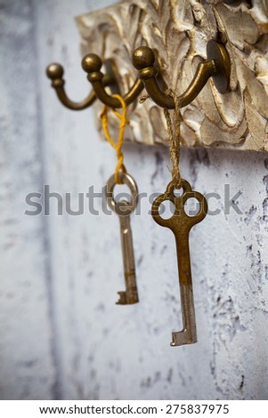 Two vintage keys hanging on hooks