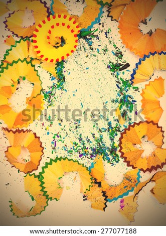colored shavings and crumb of pencil lead on white background. instagram image filter retro style