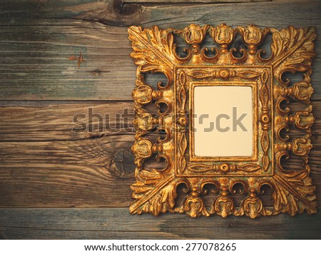 Beautiful golden vintage frame with a copy space on old textured boards. instagram image filter retro style