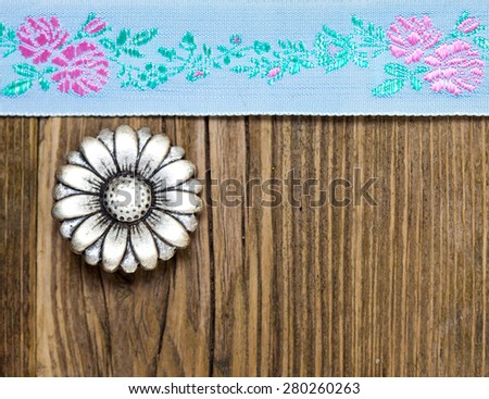 still life, vintage aqua color tape with embroidered ornaments and old button flower