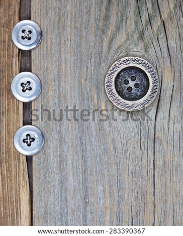 four vintage button on the aged textured boards of the old tailor table