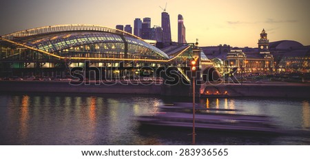 Night cityscape Moscow city with bridge, river and motion boat. Long exposure. Instagram image filter retro style