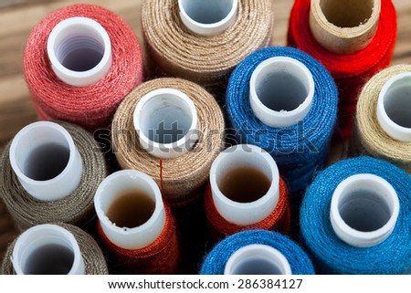 several varicolored spools of thread with copy space. shallow depth of field