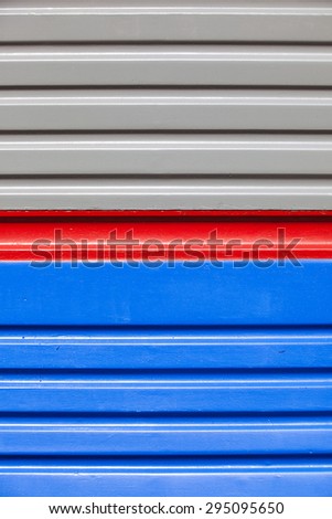 blue-gray background with a red stripe. wall of an old railway car