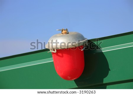 Red-Silvery Object is Dyed on Blue Green Background