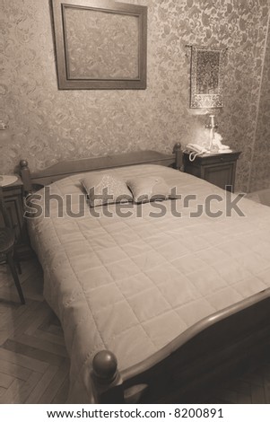 comfortable bedroom with wooden old-time bed, vintage
