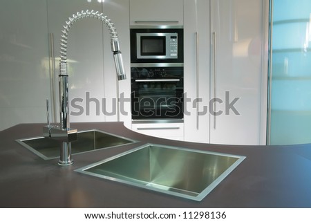 modern metallic sink with graceful tap on the super-modern kitchen