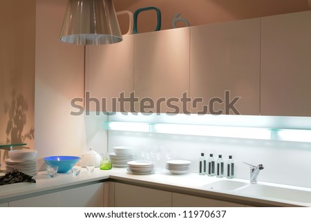 Modern Beige Kitchen With Blue Tureen And Shade On The Wall Stock ...