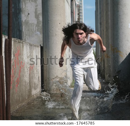 running on water man in white cloth with long hair