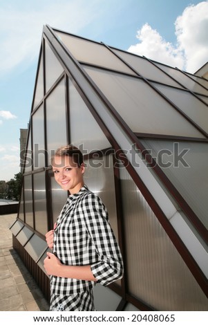 young architect on background of the metallic-glass modern construction