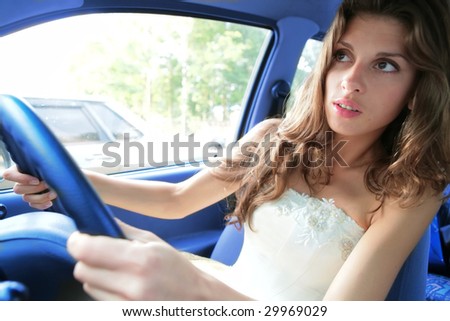 luxurious young woman in white cloth drives a car