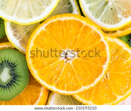 Collection of fruits slices. Orange, lemon and kiwi closeup. Healthy food background