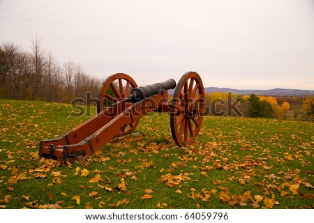 Revolutionary war era cannon taken on a cloudy overcast day in a leaf strewn field