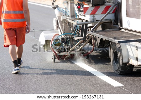 Thermoplastic spray marking machine during road construction works