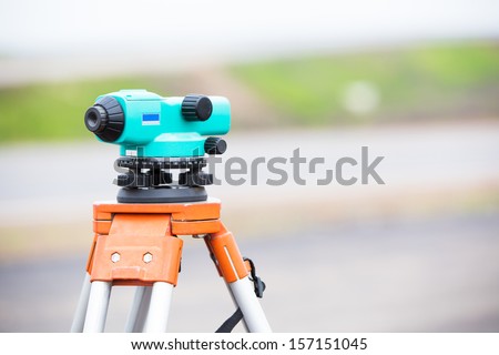 Land surveying equipment theodolite during construction road works