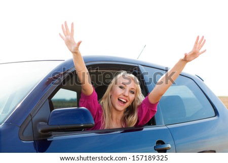 Happy blonde girl driver in car window